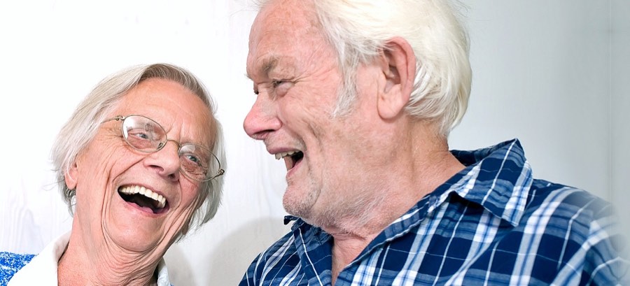 A senior couple laughing together